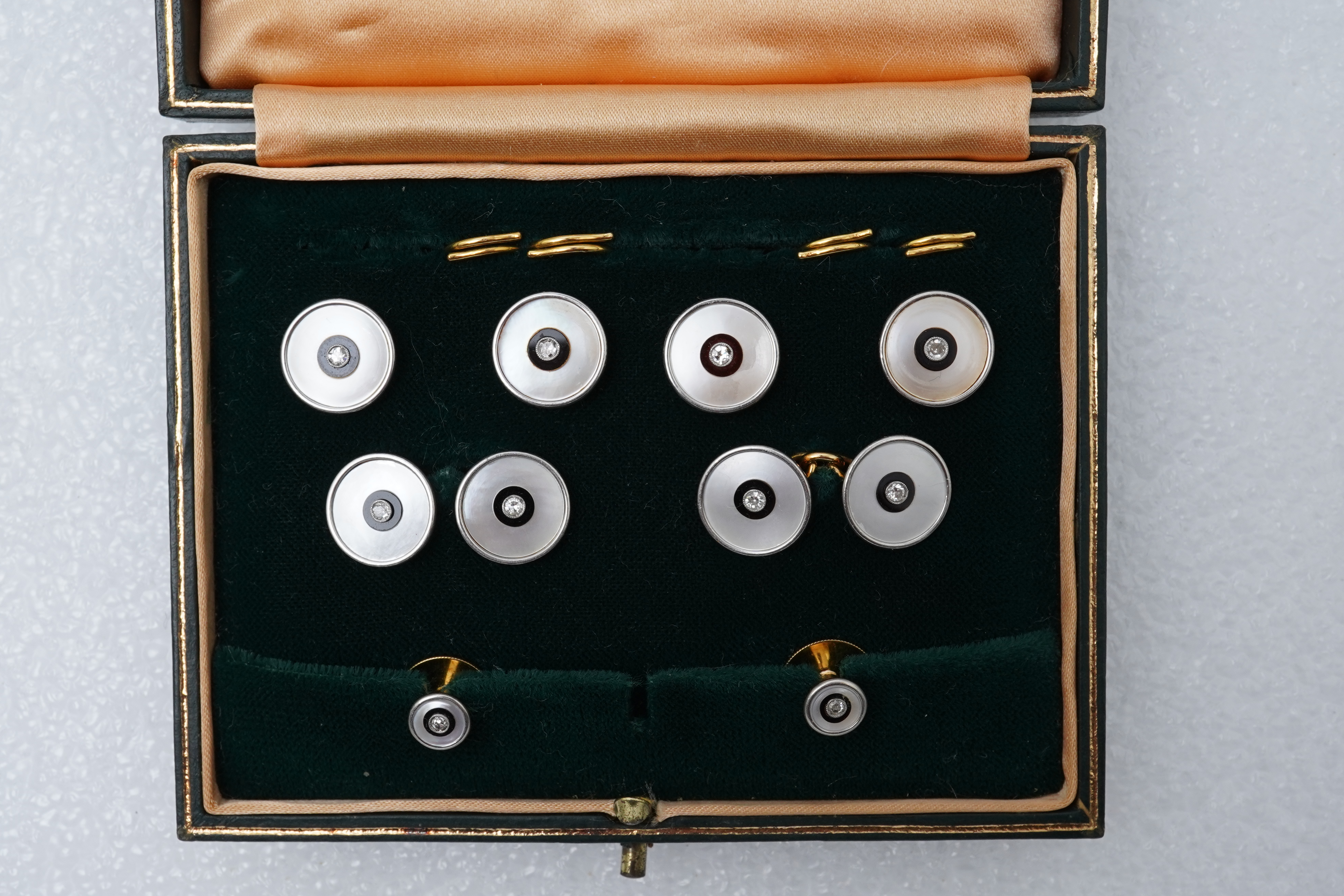 An Art Deco mother of pearl, onyx and diamond dress set, early 20th century